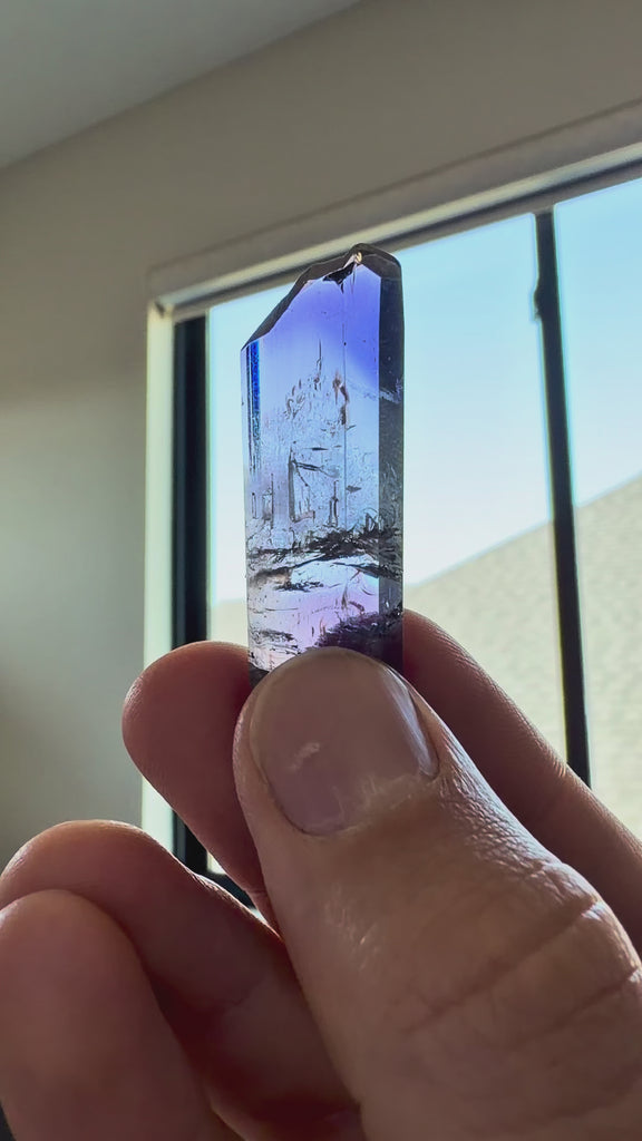 Video showing an unheated gem clean tanzanite crystal specimen with trichroic color shifts